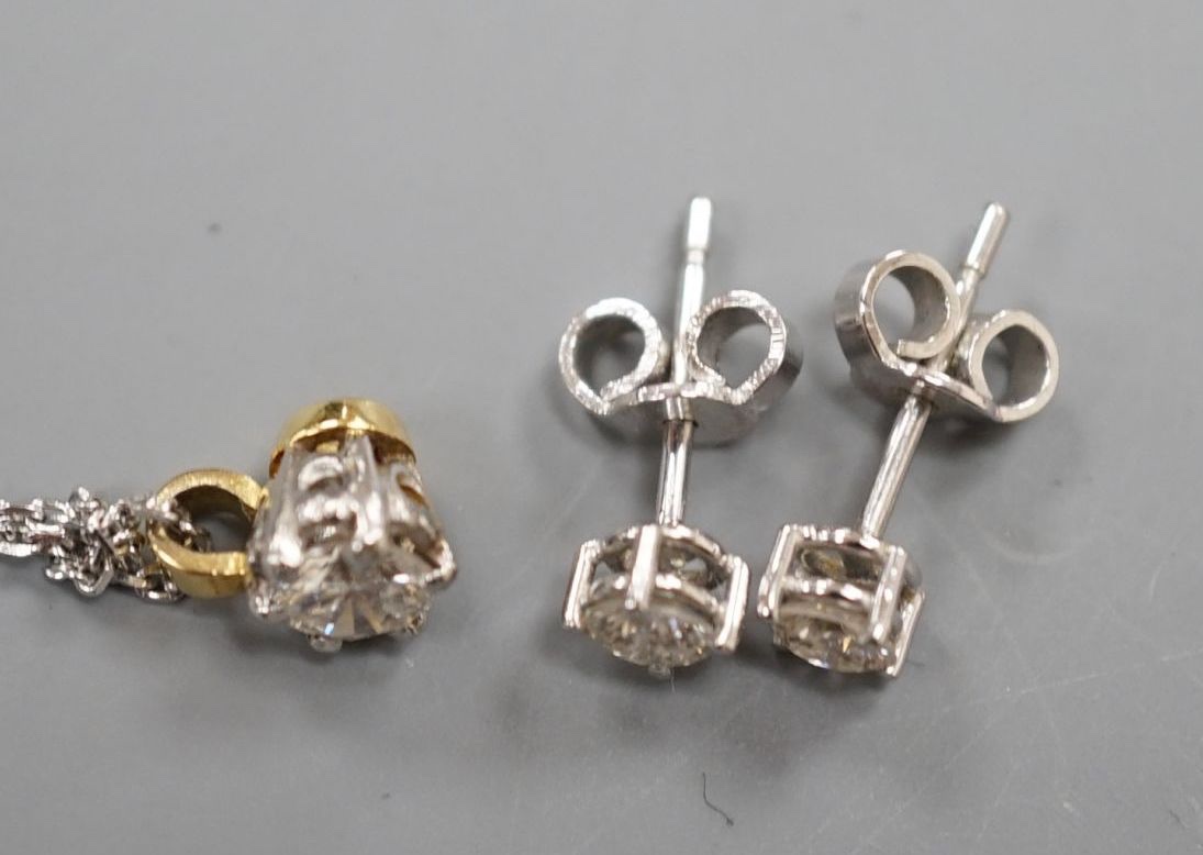 A pair of 18ct and solitaire diamond set ear studs, gross 1 grams and a solitaire diamond pendant on a 375 chain, gross 2.5 grams.